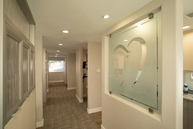 Hallway with a frosted glass panel etched with the practice logo