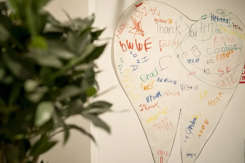 Tooth-shaped thank-you poster signed by young patients