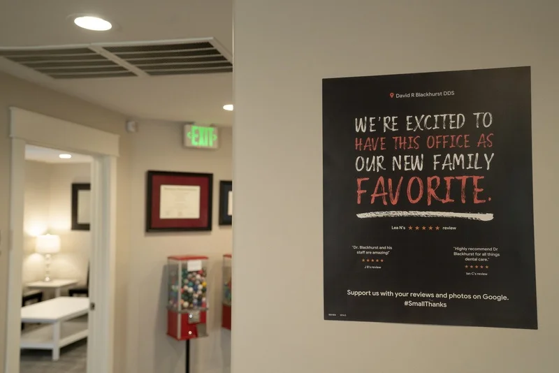 Patient review poster and a gumball machine in the office hallway